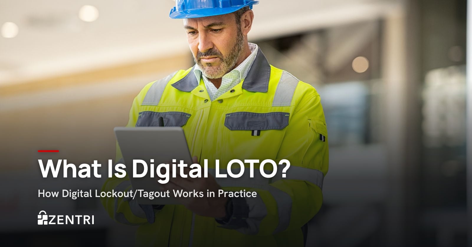 Engineer in a hard hat and hi-vis vest using a tablet on site